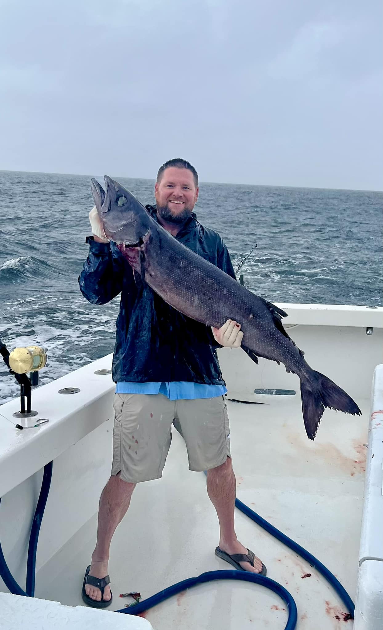 man holding freshly caught large deep sea fish